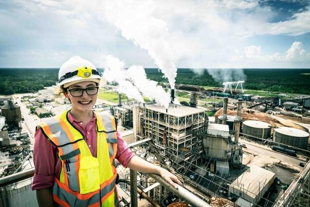 A woman engineer has an aerial view of a paper mill